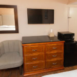 guestroom amenities including microwave, min fridge, TV and dresser